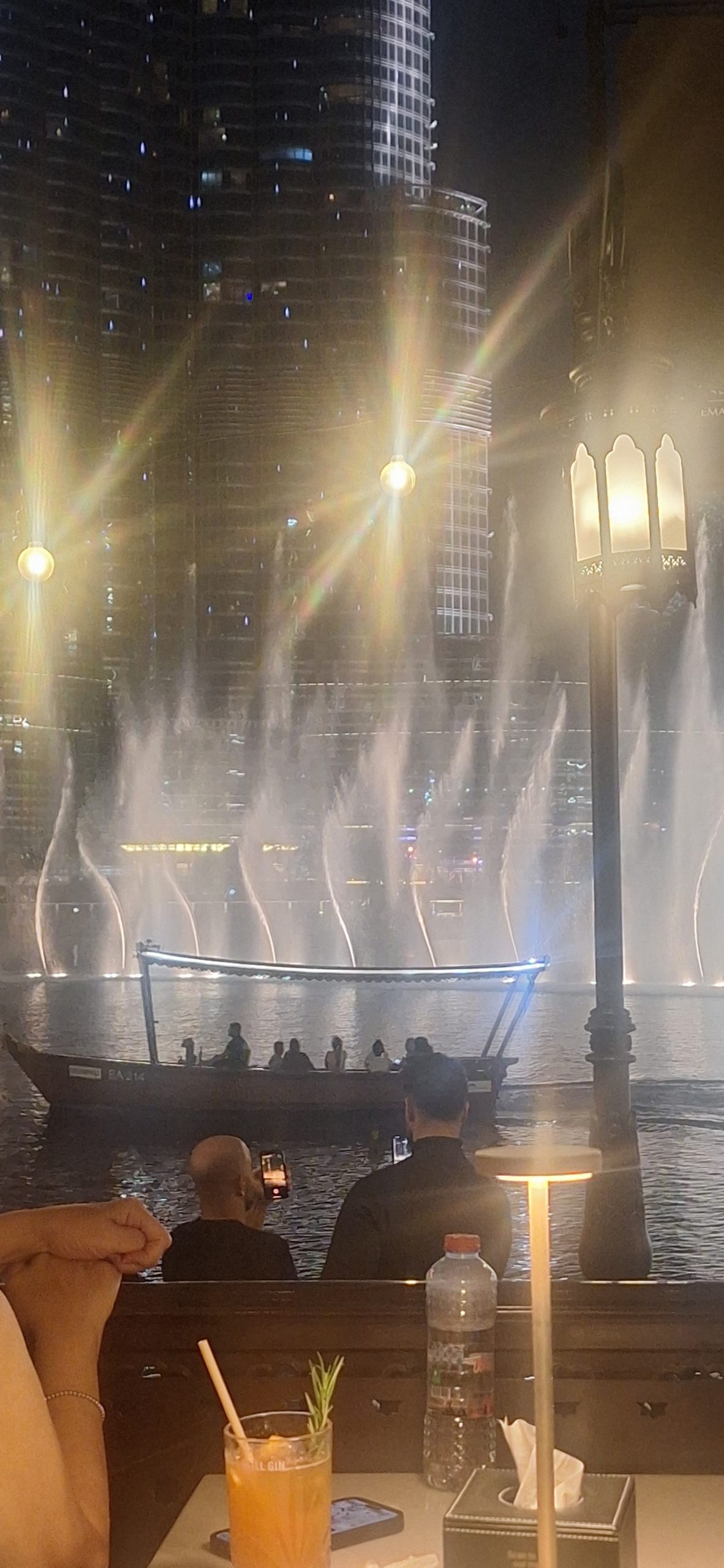 Dubai Mall fountain show at night from lakeside restaurant